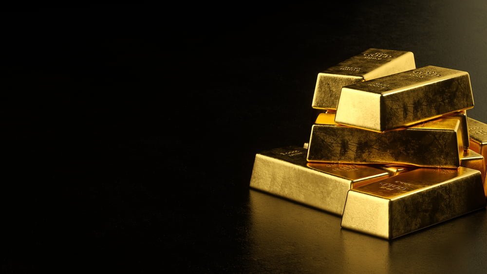 Zlaté cihly na černé pozadí, koncept aktuální cena zlata na světových trzích