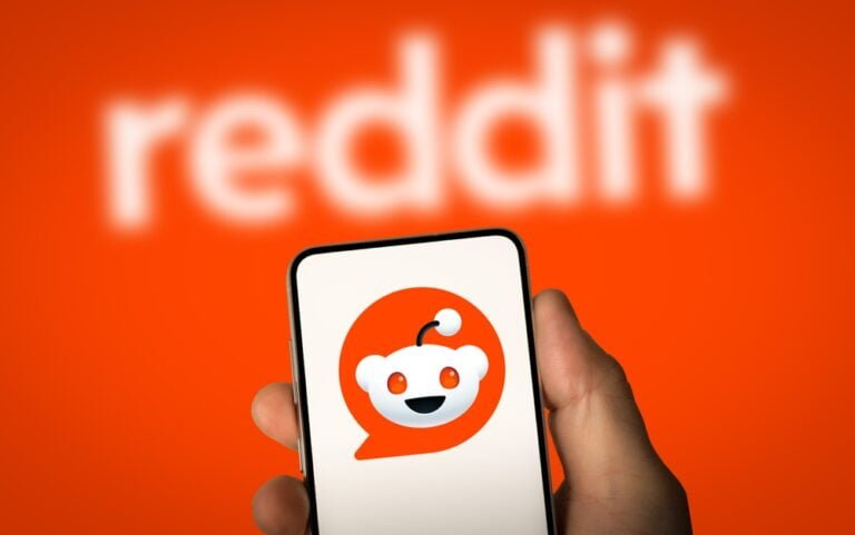 phone with reddit app logo with red backround